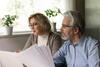 older man and women reading paperwork